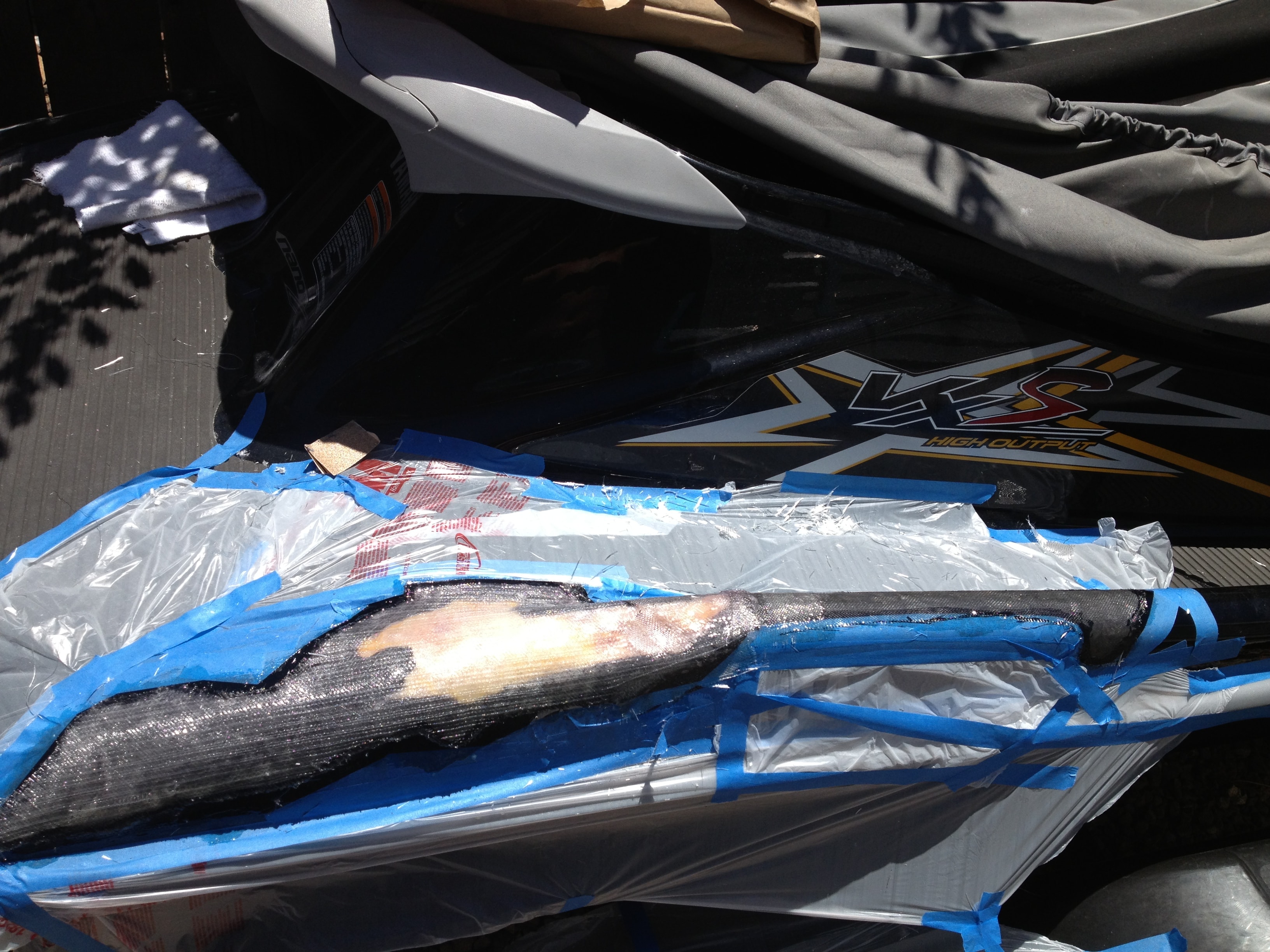 Step 7 — PWC fiberglass repair curing close-up, San Diego Yacht Repair